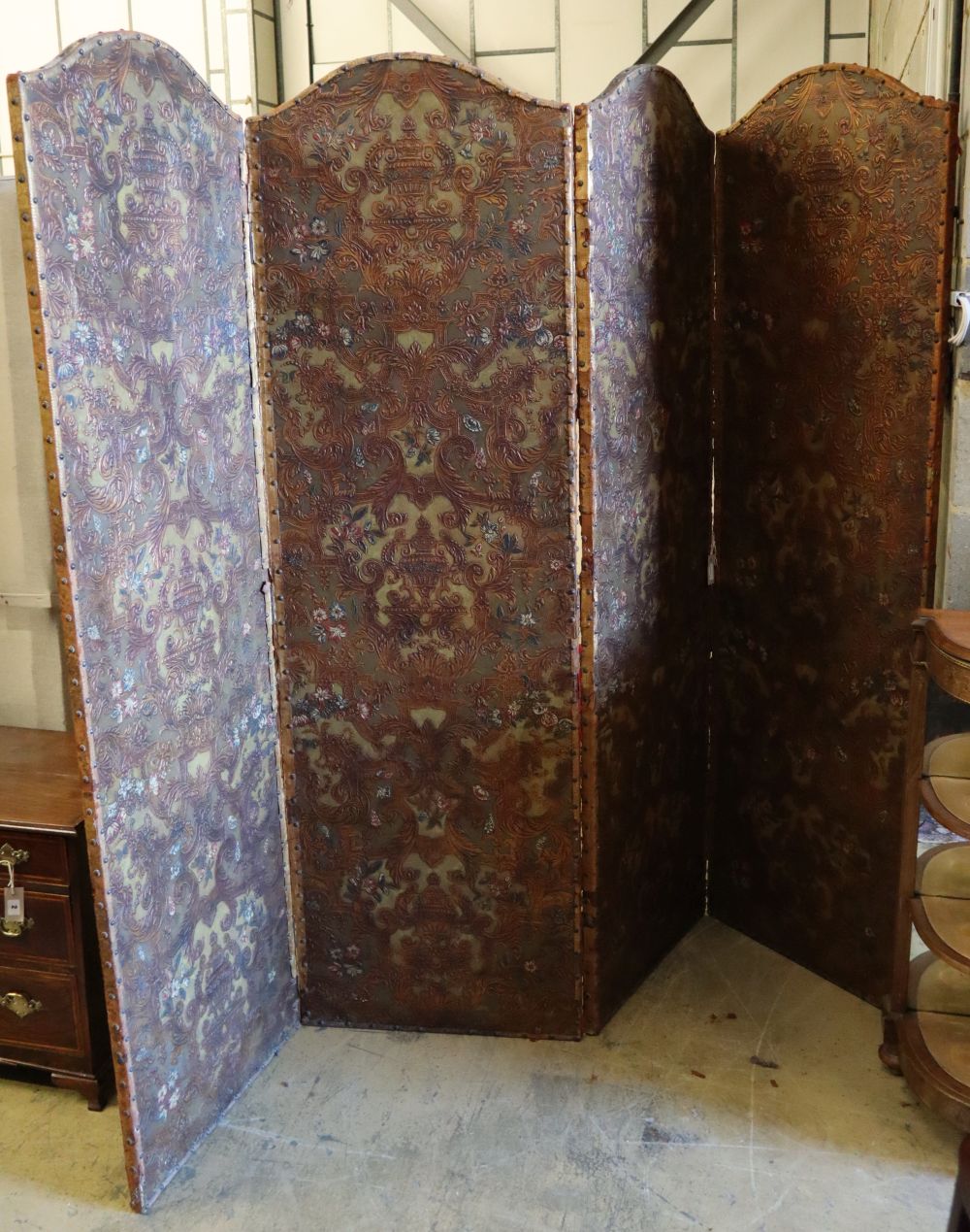 A Spanish embossed leather four-fold screen with painted and gilded leaf, flower and scroll decoration, 198 x 61cm (per panel)